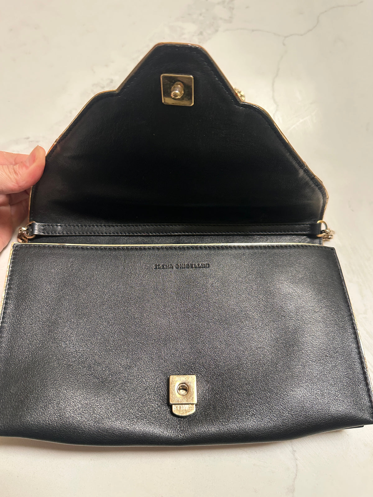Elena Ghisellini Feline clutch in black leather with gold detail
