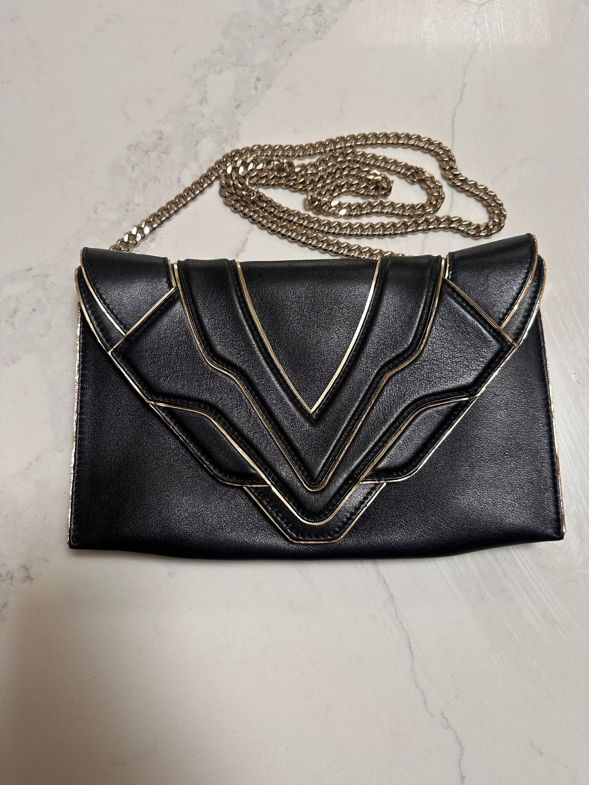 Elena Ghisellini Feline clutch in black leather with gold detail