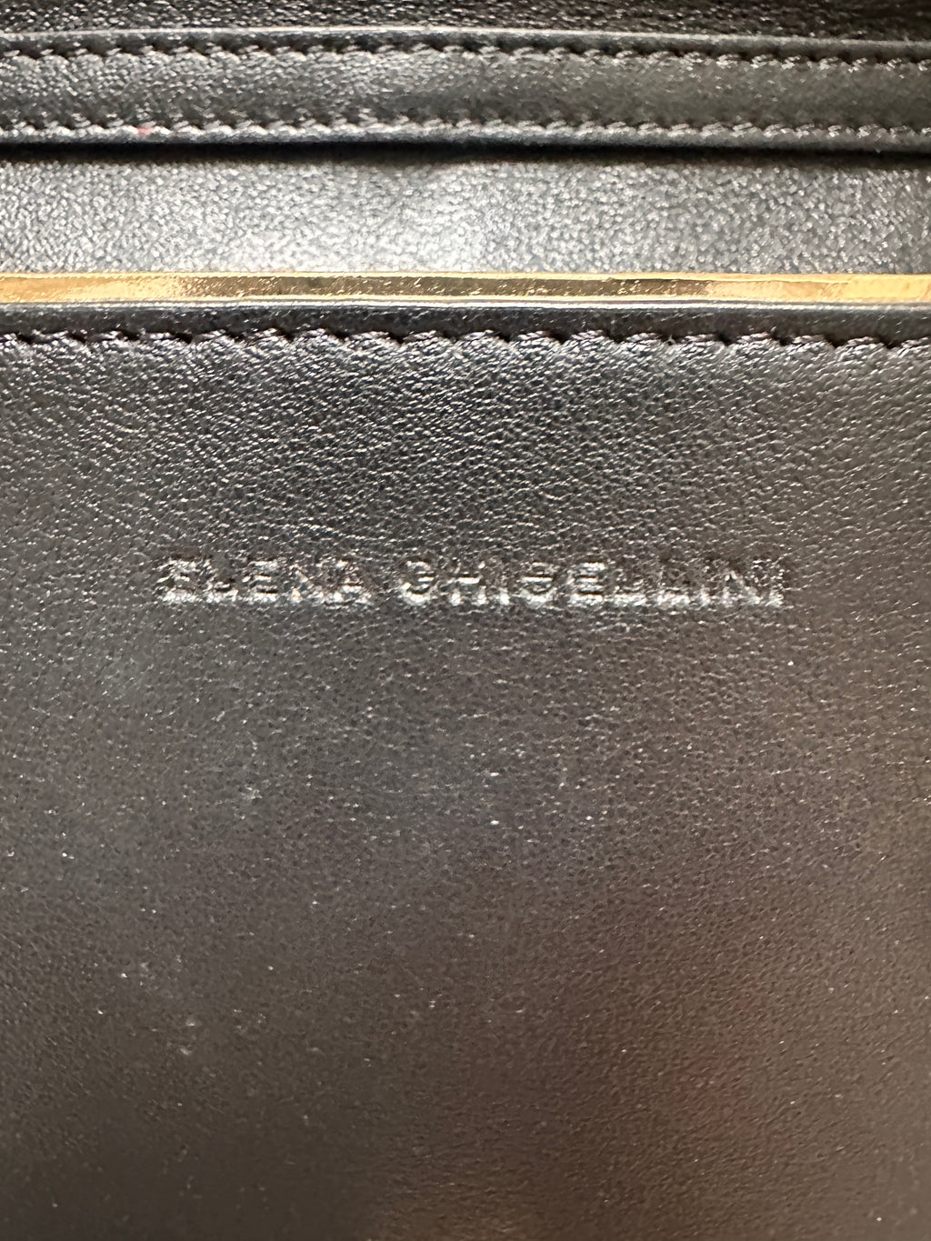 Elena Ghisellini Feline clutch in black leather with gold detail