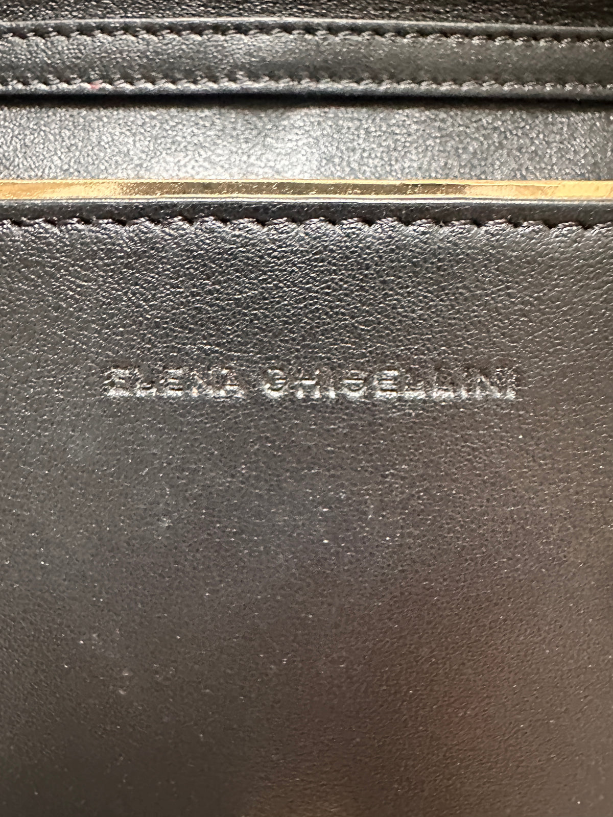 Elena Ghisellini Feline clutch in black leather with gold detail