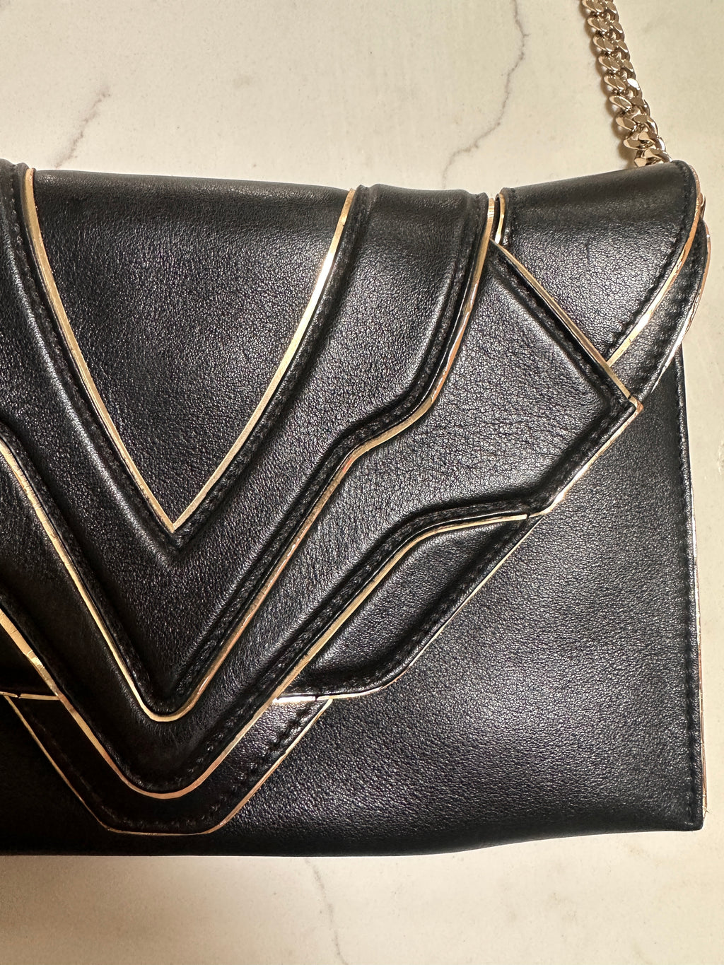 Elena Ghisellini Feline clutch in black leather with gold detail