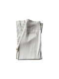 The Renewal Edit cream high-waisted tailored trousers with a slim leg and back pocket detail on a white background.